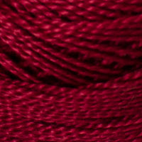 A close-up of deep burgundy red yarn wound tightly, showing the texture and color of the fiber.