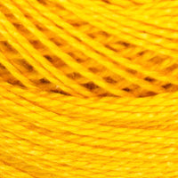 A close-up of bright yellow yarn wound into skeins, filling the entire frame.