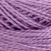 A close-up of lavender purple yarn wound into skeins, showing the twisted fiber texture.